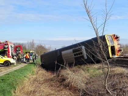 A train lays in a ditch after derailing following a crash with a car close to Mindszent, 140 kilometres (86 miles) southeast of Budapest on April 5, 2022. - Five people died in the train crash when a van drove onto the rails at a crossing, causing the train to …