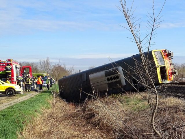 A train lays in a ditch after derailing following a crash with a car close to Mindszent, 1