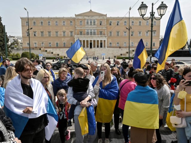 Ukrainians living in Greece gather outside the Greek Parliament and listen to Ukraine Pres