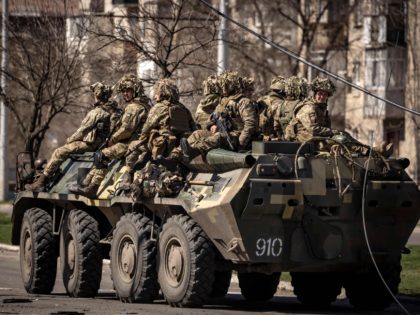Ukrainian soldiers sit on a armoured military vehicule in the city of Severodonetsk, Donbas region, on April 7, 2022, amid Russia's military invasion launched on Ukraine. - Six weeks after invading its neighbour, Russia's troops have withdrawn from Kyiv and Ukraine's north and are focusing on the country's southeast, where …