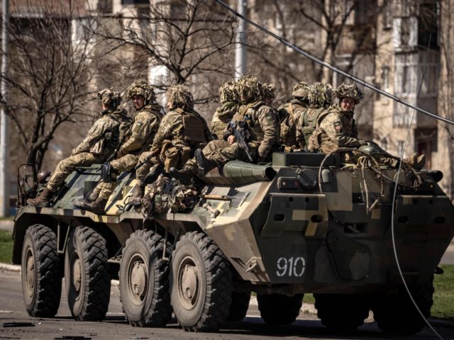 Ukrainian soldiers sit on a armoured military vehicule in the city of Severodonetsk, Donba