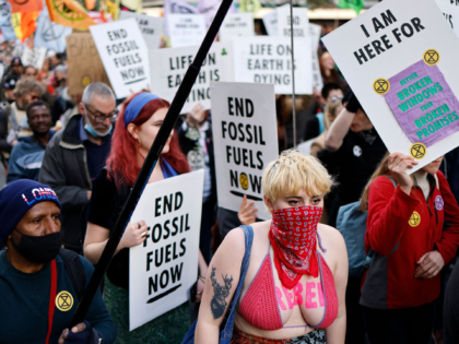 Activists march along Oxford Street during a demonstration by the climate change protest group Extinction Rebellion in London on April 9, 2022, during a series of actions aiming to stop the fossil fuel economy. - Extinction Rebellion climate protesters have recently staged several protests at oil terminals and refineries across …