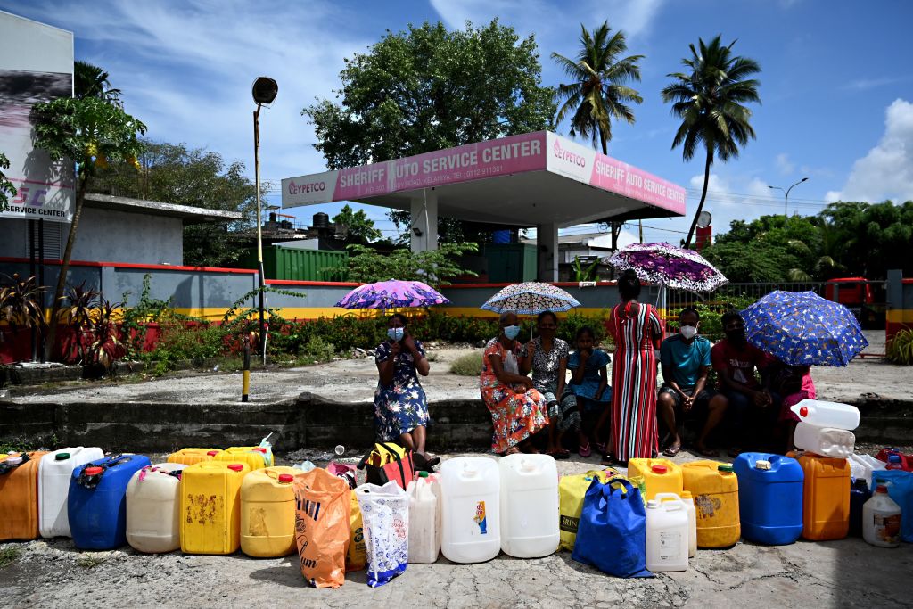 People queue to buy kerosene oil for their homes in Colombo on April 11, 2022. (ISHARA S. KODIKARA/AFP via Getty Images)