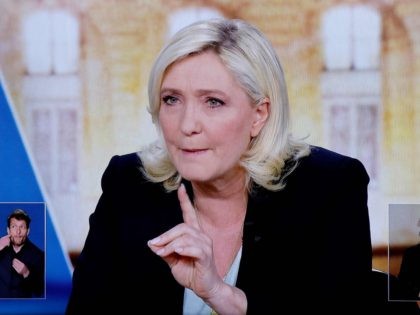 A picture shows a TV screen displaying French far-right party Rassemblement National (RN) presidential candidate Marine Le Pen during a live televised debate with French President and La Republique en Marche (LREM) party candidate for re-election Emmanuel Macron, broadcasted on French TV channels TF1 and France 2, in Saint-Denis, north …