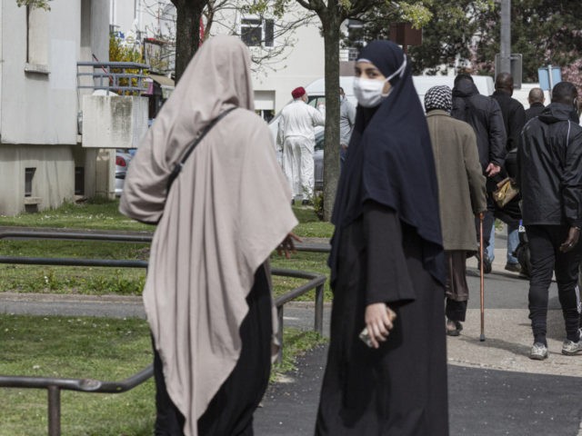 PARIS, FRANCE - APRIL 09: A woman wearing traditional Islamic clothing walks through Pantin on April 9, 2021 in Paris, France. A proposed "Anti-Separatism' bill currently in front of France's National Assembly has faced a backlash for an amendment that would ban the wearing of Muslim headscarves for those under …