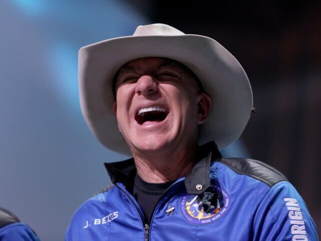 VAN HORN, TEXAS - JULY 20: Jeff Bezos laughs as he speaks about his flight on Blue Origin’s New Shepard into space during a press conference on July 20, 2021 in Van Horn, Texas. Mr. Bezos and the crew that flew with him were the first human spaceflight for the …