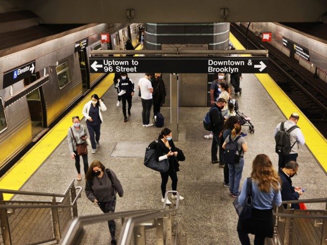 People walk along the train platform at the Second Avenue subway station on November 09, 2