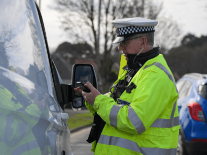 BOURNEMOUTH, ENGLAND - FEBRUARY 17: Police Officers deal with motorists for offences during the operation, on February 17, 2022 in Bournemouth, England. The operation, which falls within the National Police Chiefs' Council mobile phone week of action, sees officers working from one of Yellow Buses double decker buses observing driver …