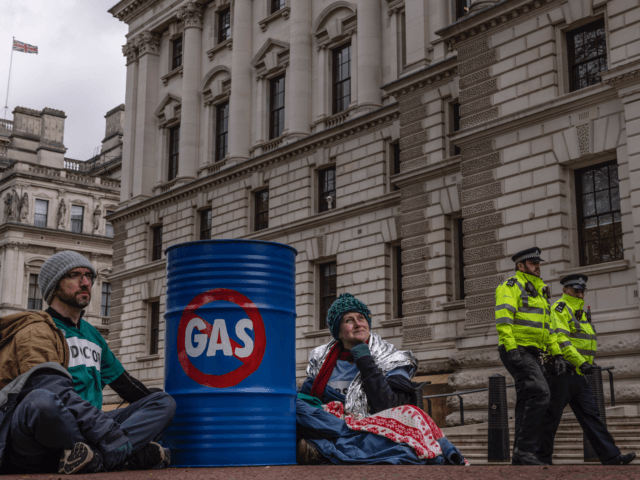 LONDON, ENGLAND - APRIL 07: Extinction Rebellion (XR) protesters glue themselves to barrel