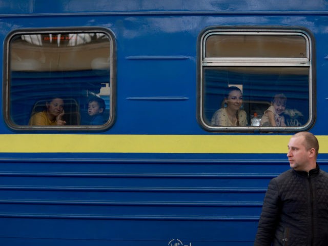 LVIV, UKRAINE - APRIL 11: People wait on the train to Poland at the central train station