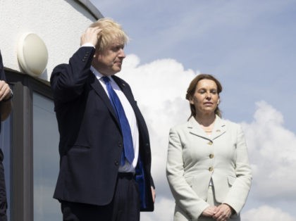 DOVER, ENGLAND - APRIL 14: L-R Dan O'Mahoney, the Clandestine Channel Threat Commander, Boris Johnson, MP for Dover Natalie Elphicke and John Craig. Deputy Commander and Chief of Staff to the Commander of the UK Carrier Strike Group at Royal Navy stand overlooking the channel on April 14, 2022 in …