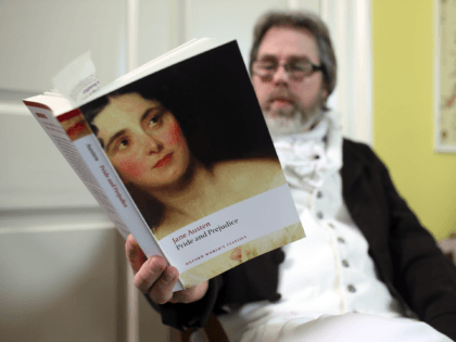BATH, ENGLAND - JANUARY 28: A reader waits as part-time actor Ashley Green (not seen) reads chapter ten of Jane Austen's Pride and Prejudice at the Jane Austen Centre on January 28, 2013 in Bath, England. To celebrate the 200th anniversary of the publication, book experts, writers and fans are …