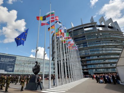 Soldiers of a Eurocorps detachment raise the European Union flag to mark the inaugural European Parliament session on June 30, 2014, in front of the European Parliament in Strasbourg, eastern France. AFP PHOTO / PATRICK HERTZOG (Photo credit should read PATRICK HERTZOG/AFP via Getty Images)