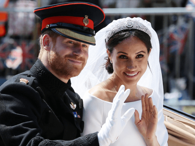 TOPSHOT - Britain's Prince Harry, Duke of Sussex and his wife Meghan, Duchess of Sussex wa