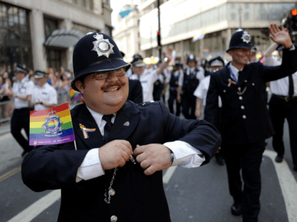 Police officers join supporters and members of the Lesbian, Gay, Bisexual and Transgender (LGBT) community taking part in the annual Pride Parade in London on July 7, 2018. (Photo by Tolga AKMEN / AFP) (Photo credit should read TOLGA AKMEN/AFP via Getty Images)