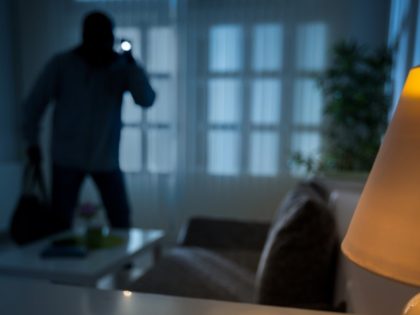 Home intruder shines a flashlight.