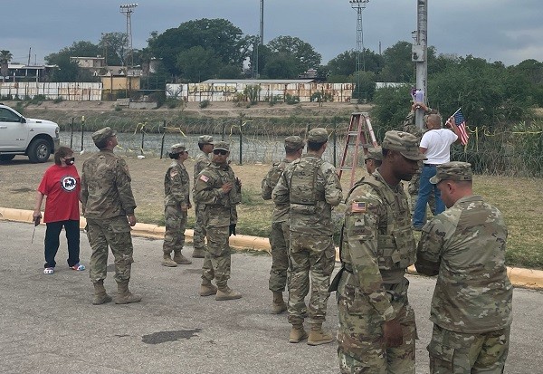Texas National Guardsmen and local residents began a makeshift memorial for SPC Bishop Evans following the finding of his remains on Monday. (Randy Clark/Breitbart Texas)