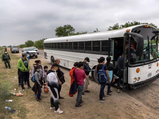 LA JOYA, Texas: Central American families board a U.S. Customs and Border Protection bus for transport to an immigrant processing center after crossing the border from Mexico on April 13, 2021, in La Joya, Texas. A surge of immigrants crossing into the United States, including record numbers of children, has challenged U.S. immigration agencies along the southern border. (Moore/Getty Images)