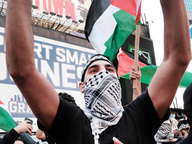 Pro Palestinian protesters face off with a group of Israel supporters and police in a violent clash in Times Square on May 20, 2021 in New York City. Despite an announcement of a cease fire between Israel and Gaza militants, dozens of supporters of both sides of the conflict fought …