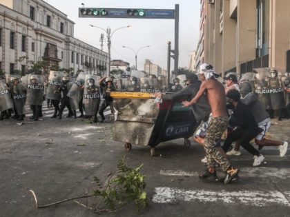 Demonstrators clash with police on a street in Lima, Peru, Tuesday, April 5, 2022. Riots erupted when President Pedro Castillo lifted a curfew he had decreed less than a day earlier in the country’s capital and its main port in a bid to quell sometimes violent protests over rising fuel …