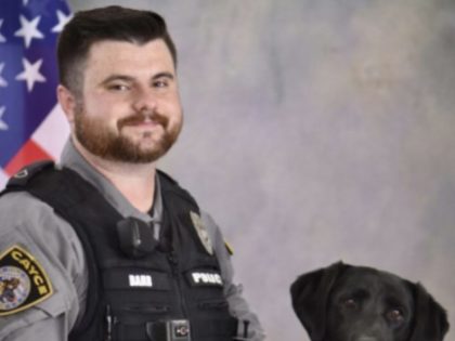 This photo provided by the Cayce, South Carolina, Police Department shows Officer Roy Andrew "Drew" Barr with K-9 black Labrador retriever Molly. Police said Barr, responding to a domestic disturbance, was killed when a man opened fire on him and two other officers early Sunday, April 24, 2022.