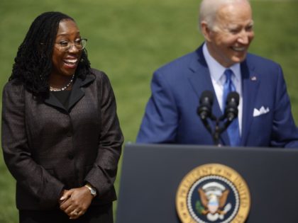 WASHINGTON, DC - APRIL 08: Judge Ketanji Brown Jackson smiles as U.S. President Joe Biden speaks at an event celebrating her confirmation to the U.S. Supreme Court on the South Lawn of the White House on April 08, 2022 in Washington, DC. Judge Jackson was confirmed by the Senate 53-47 …