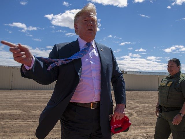 President Donald Trump speaks as he visits a new section of the border wall with Mexico in