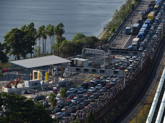 Vehicles form a long queue to enter Woodlands checkpoint in Singapore on March 17, 2020 fr