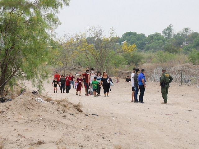 A large group of migrant family units cross the border on the eve of Easter near Eagle Pas
