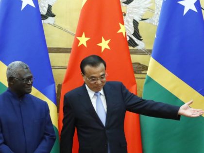 FILE - Solomon Islands Prime Minister Manasseh Sogavare, left, and Chinese Premier Li Keqiang attend a signing ceremony at the Great Hall of the People in Beijing, on Oct. 9, 2019. In an announcement Thursday, March 31, 2022, China and the Solomon Islands have signed a draft version of a …