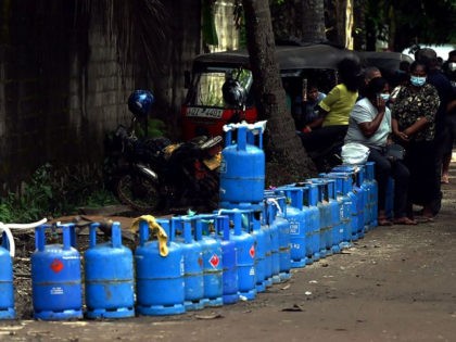 People queue to buy Liquefied Petroleum Gas (LPG) cylinders in Colombo on April 11, 2022.