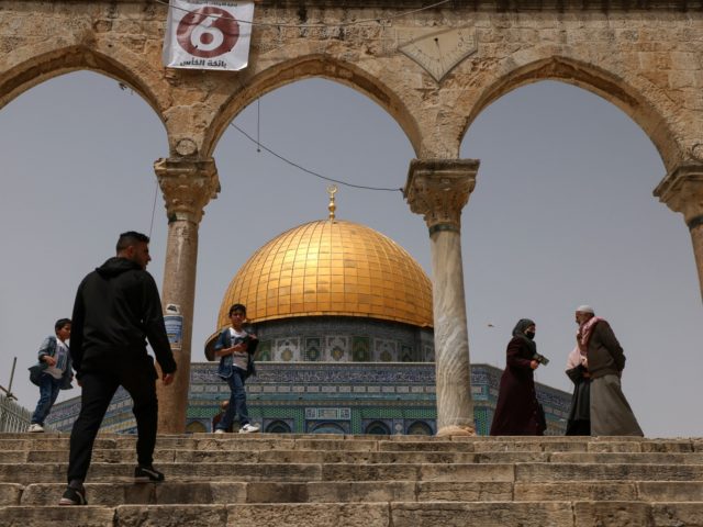 Palestinian Muslims gather in front of the Dome of Rock mosque at the Al-Aqsa mosque compo