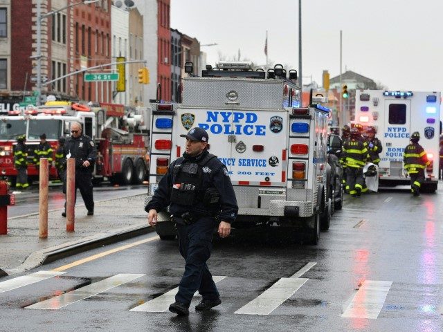 Members of the New York Police Department and emergency personnel crowd the streets near a