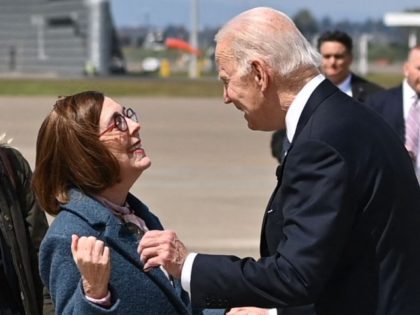 US President Joe Biden is greeted by Oregon Governor Kate Brown upon arrival at Portland International Airport in Portland, Oregon on April 21, 2022.