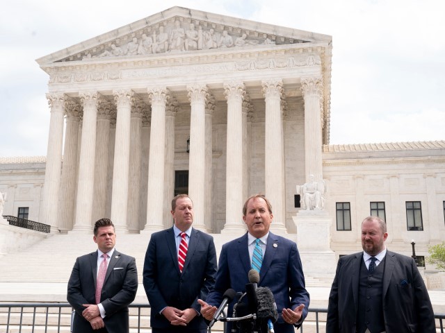 Texas Attorney General Ken Paxton (2R) and Missouri Attorney General Eric Schmitt (2L) speak to reporters in front of the US Supreme Court in Washington, DC, on April 26, 2022. The Supreme Court will hear oral arguments Tuesday in the Biden v. Texas case, which will determine if the Biden administration must continue to enforce a Trump-era program known as the Remain in Mexico policy. 