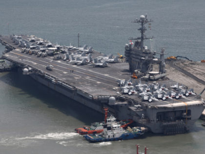 BUSAN, SOUTH KOREA - JULY 11: US aircraft carrier USS George Washington sits at anchor in Busan port on July 11, 2014 in Busan, South Korea. The U.S. Navy's aircraft carrier USS George Washington (CVN 73) and associated ships from the George Washington Strike Group is visiting Busan from July …