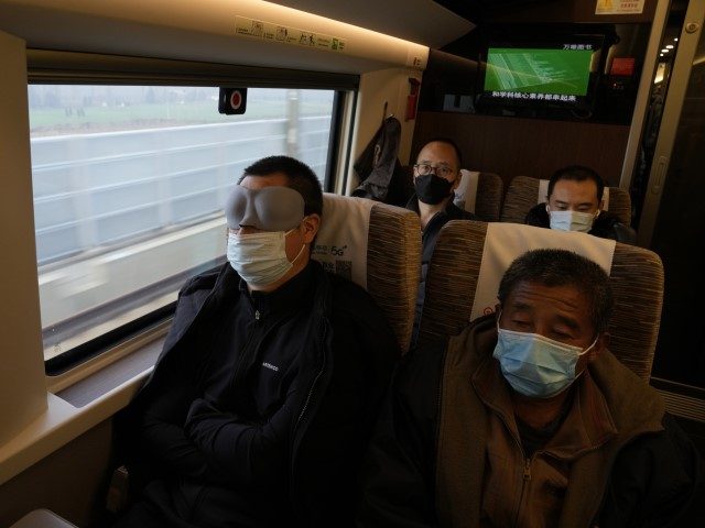 Passengers on board a high speed train from Beijing to Shanghai wear masks to curb the spr
