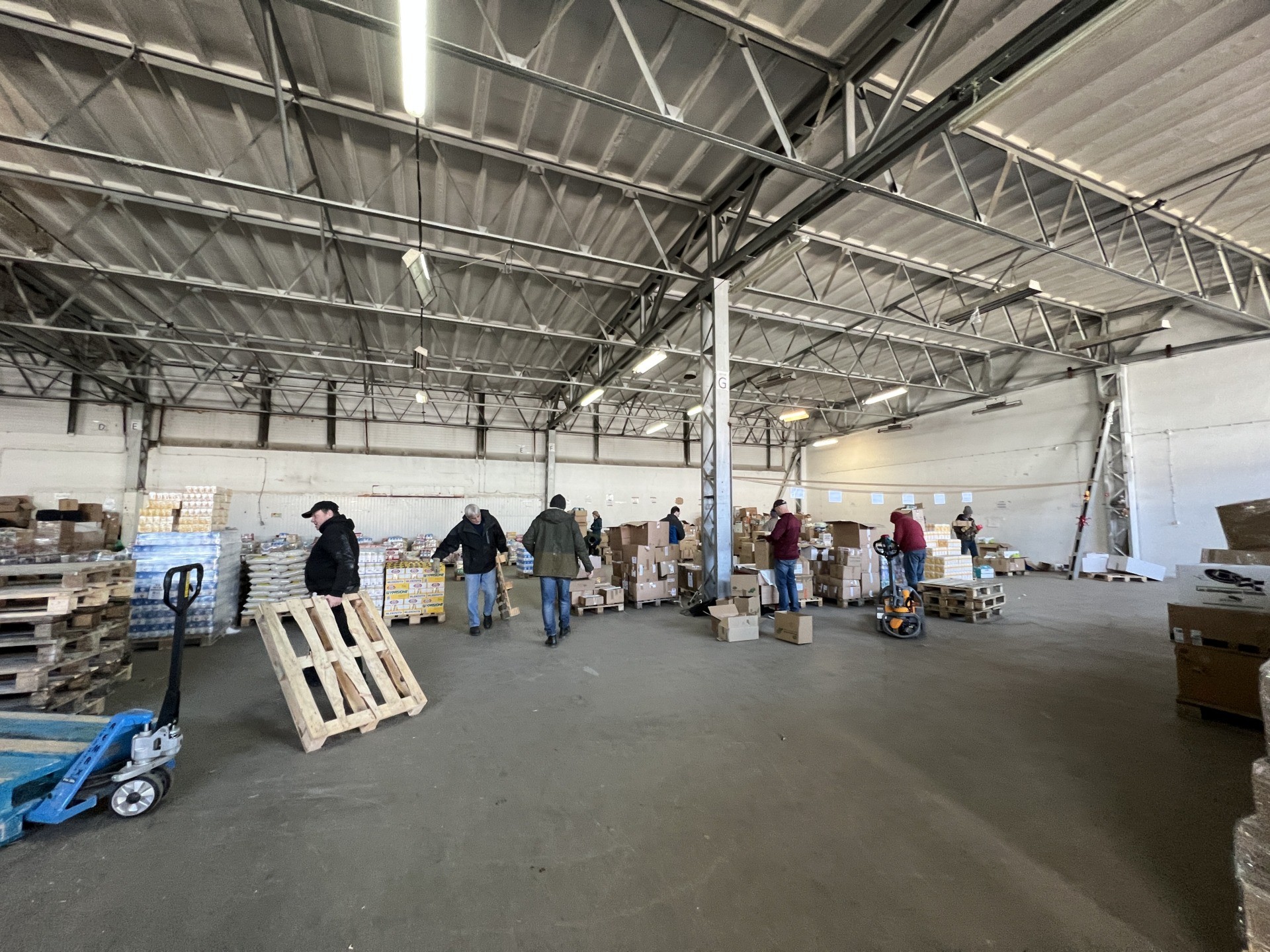 Volunteers in the warehouse. (Kristina Wong/Breitbart News)