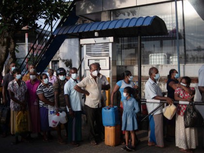 DIKWELLA, SRI LANKA - APRIL 05: People queue for kerosene oil amid the country’s ongoing fuel shortage at a gas station on April 05, 2022 in Dikwella, Sri Lanka. Protesters have taken to the streets in fiery scenes as Sri Lanka's economy faces soaring inflation, dwindling supplies, power cuts and …