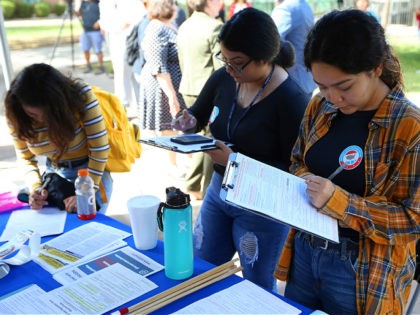 Phoenix College students fill out voter registration forms at Phoenix College on National Voter Registration Day Tuesday, Sept. 24, 2019, in Phoenix. (AP Photo/Ross D. Franklin)