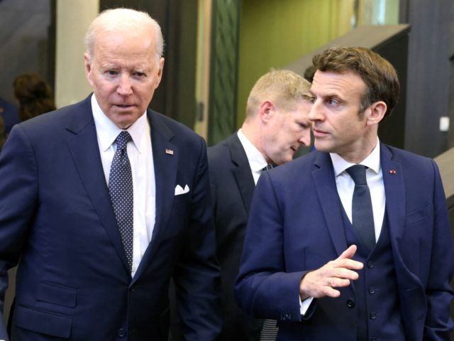 U.S. President Joe Biden (L) talks with French President Emmanuel Macron as they arrive to