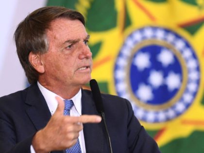Brazilian President Jair Bolsonaro delivers a speech during the announcement of the hiring of professionals for the Doctors for Brazil Program at Planalto Palace in Brasilia, on April 18, 2022. - Brazil announced on April 17, 2022, it will "in the coming days" lift public health emergency measures in place …