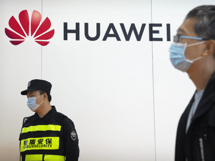 A security guard stands near a booth for Chinese technology firm Huawei at the PT Expo in Beijing, Tuesday, Sept. 28, 2021. Chinese telecom equipment maker Huawei said Monday its 2021 sales fell but profit rose 76% despite U.S. sanctions in a year when its chief financial officer was released …