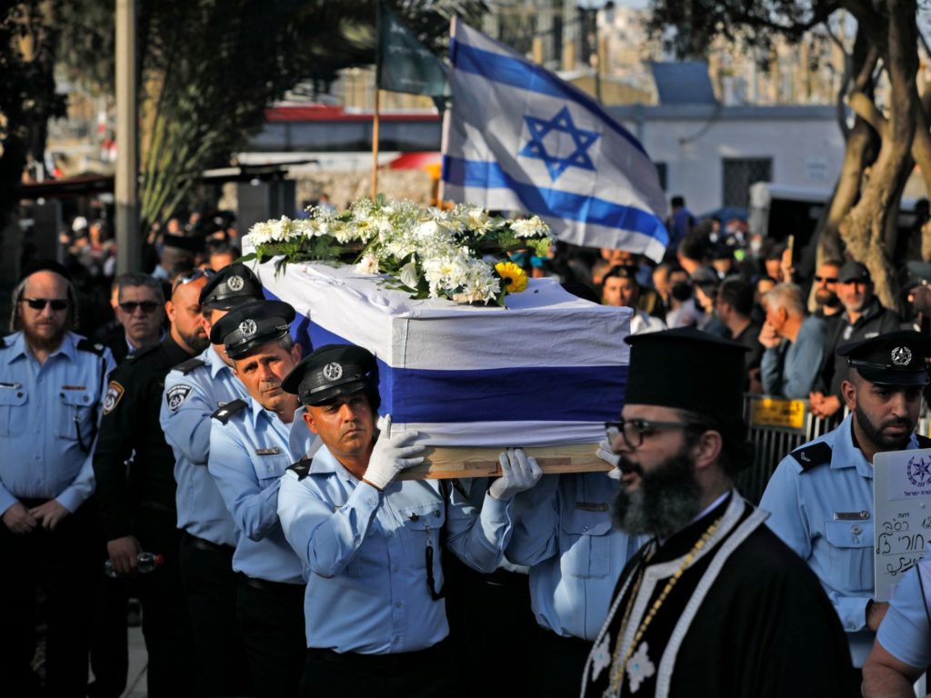 Israeli police officers carry the coffin of Israeli Arab policeman Amir Khoury, 32, one of the five people killed in a shooting attack in the religious town of Bnei Brak, during his funeral in Nazareth on March 31, 2022. (Photo by JALAA MAREY / AFP) (Photo by JALAA MAREY/AFP via Getty Images)