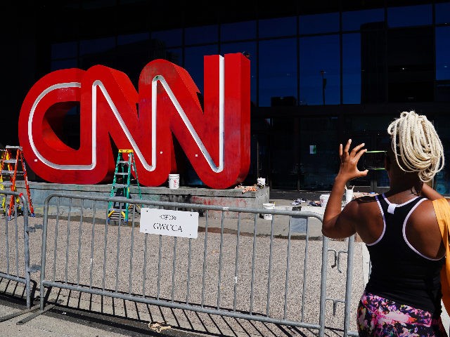 ATLANTA, GA - MAY 30: A woman takes a photo of the CNN sign following an overnight demonstration over the Minneapolis death of George Floyd while in police custody on May 30, 2020 in Atlanta, Georgia. Demonstrations are being held across the U.S. after George Floyd died in police custody …