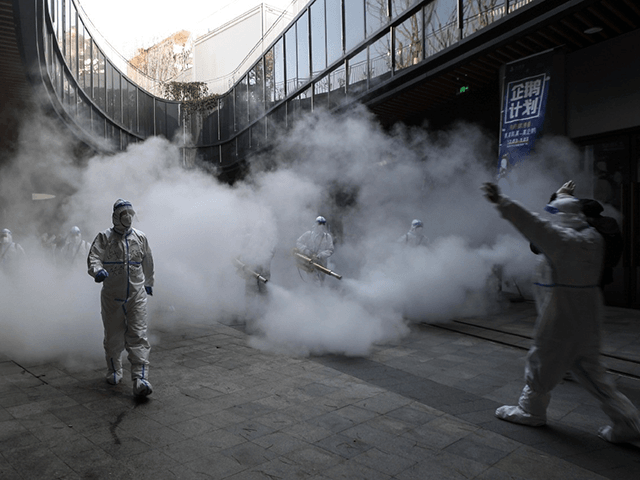 Disinfectant is sprayed outside a shopping mall in Xi'an. (AFP)