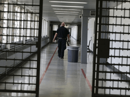 A Rikers Island juvenile detention facility officer walks down a hallway of the jail, Thursday, July 31, 2014, in New York. It's hard to find anyone on board with New York Gov. Kathy Hochul's plan to toughen the state's bail laws, two years after they were retooled to keep people …