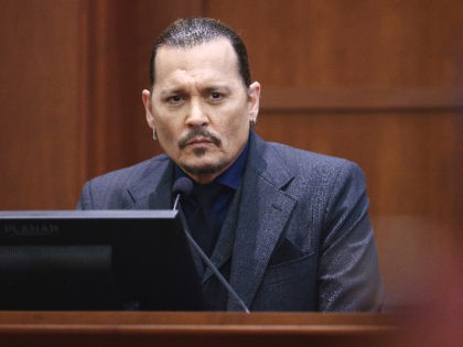 Actor Johnny Depp listens as he testifies in the courtroom at the Fairfax County Circuit C