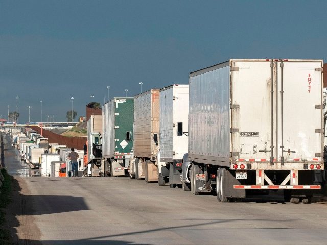 Trucks line up before heading to the United States at the Otay commercial port of entry on the US-Mexico border in Tijuana, Baja California State, Mexico, on March 20, 2020. - Mexico and the United States have agreed to 'restrict non-essential' border crossings in an attempt to slowdown the COVID-19 …