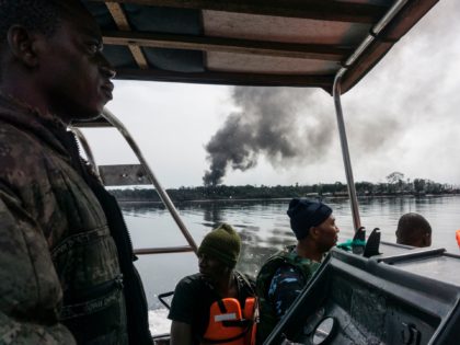 TOPSHOT - Members of the NNS Pathfinder of the Nigerian Navy forces are out on patrol looking for illegal oil refineries on April 19, 2017 in the Niger Delta region near the city of Port Harcourt. NNS Pathfinder of the Nigerian Navy forces are cracking down on illegal oil refineries …